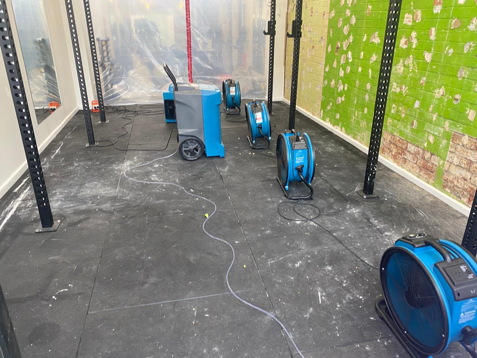 Drying equipment set up in a residential interior after water damage